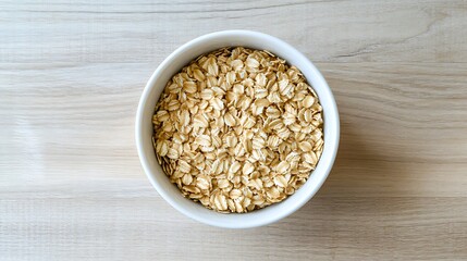 Bowl of Rolled Oats on Wooden Surface