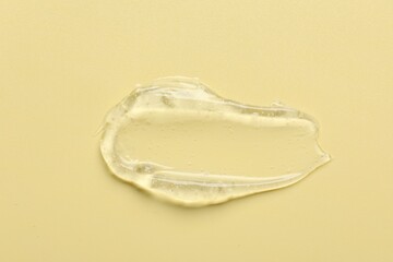Collagen gel on yellow background, above view. Space for text