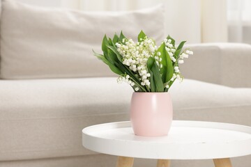 Fototapeta premium Bouquet of beautiful lily-of-the-valley on coffee table indoors. Space for text