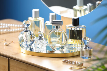 Bottles of perfumes on wooden table indoors