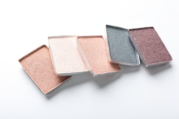 Beautiful eye shadow refill pans on white background, closeup
