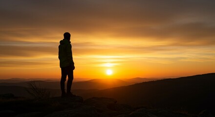 Backlit image of a hiker on a cliff at dusk, glowing sky in shades of orange and red, peaceful and cinematic atmosphere, solitary figure silhouetted against the sunset.