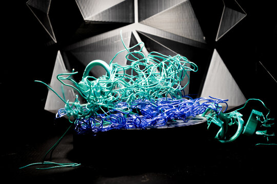 Massive spaghetti failure on a 3D printer caused by high temperatures turning filament into a fluid state.