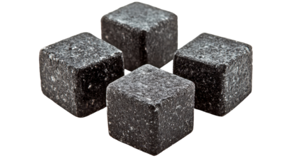 Four dark gray, speckled stone cubes arranged in a plus-sign formation against a black background