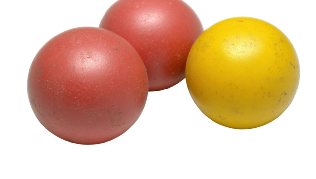 Two reddish spheres and one yellow sphere, slightly worn, rest closely together against a black background