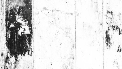 A close-up of a weathered, white surface with a black, faded poster remnant on the left edge