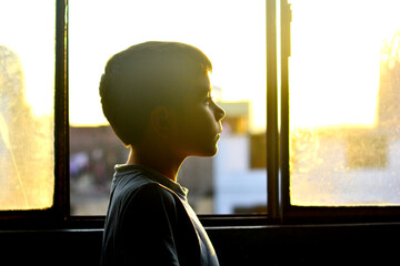 Profile of little boy indoors.
