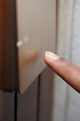 Finger pressing a button on a sleek control panel