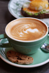 Coffee with artful foam in a cozy cafe setting