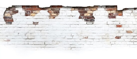 A white brick wall with exposed red brick sections at the top, showing signs of age and wear