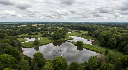 Fototapeta premium Lake Aerial View with Bridge and Green Trees