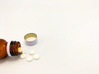 medicine bottle with pills on white