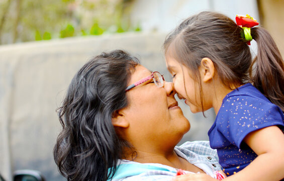 Tender portrait of indigenous South American woman with her little daughter.
