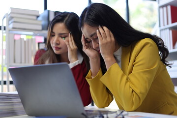 Two female employees are stressed when they receive bad news and are fired.