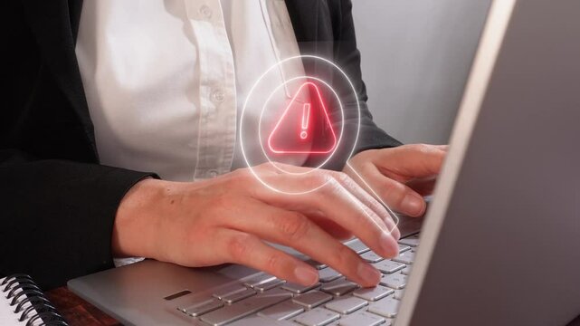 Businesswoman working on laptop with virtual magnifying glass icon with warning sign