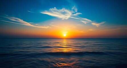 Obraz premium Ocean Sunset with Radiant Golden Light, Streaky Clouds, and Gentle Waves Reflecting the Sun