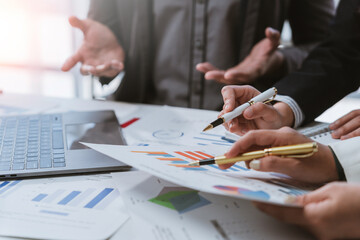 Business team collaborating and analyzing financial data, engaging in discussions about growth strategies during an important meeting