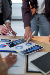 Fototapeta premium Business team working together on data analysis using charts and graphs, discussing financial results and planning strategies