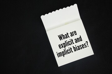 Paper book with the question words What are explicit and implicit biases?