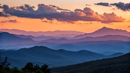 Fototapeta premium Golden hues cast over a tranquil mountain range at sunset, capturing the peaceful transition of day to night.