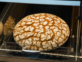 Artisan bread resting in a display showcasing its beautiful crust and texture in a rustic bakery on...