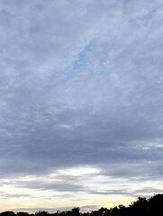 The sky is cloudy and the ocean is calm, Calm ocean waves rolling onto sandy beach under cloudy sky scenic view from above nature landscape seascape coastal scene