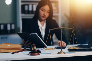 Judge gavel with Justice lawyers having team meeting at law firm background. Concepts of Law and Legal services.