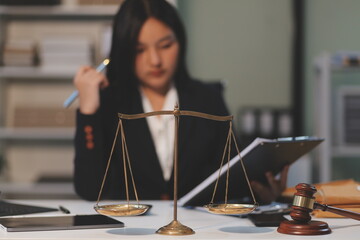 Judge gavel with Justice lawyers having team meeting at law firm background. Concepts of Law and...