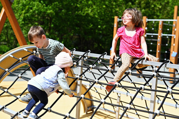Kid boy climbing on playground