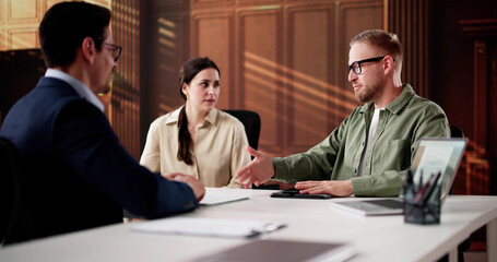Family Divorce Lawyer Consulting Young Couple In Court