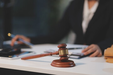 Judge gavel with Justice lawyers having team meeting at law firm background. Concepts of Law and...