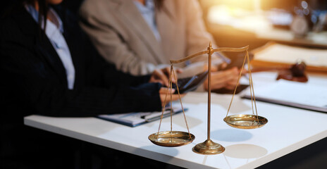 Judge gavel with Justice lawyers having team meeting at law firm background. Concepts of Law and Legal services.