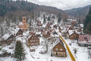 Fototapeta premium Snowy village nestled in a wintry mountain valley.