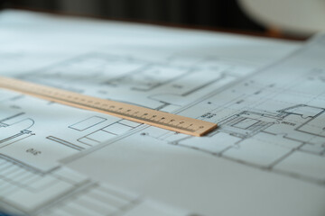 Architectural Blueprint with Wooden Ruler on Table