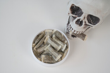 Skull Chewing Tobacco on a White Table.