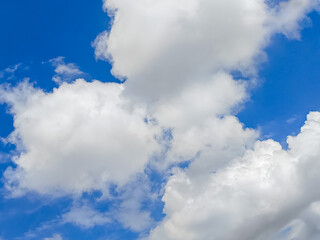Bright blue sky with large, fluffy white clouds on a clear day