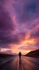 Obraz premium Lone silhouette on endless road at vibrant sunset, symbolizing soul journey and search for meaning