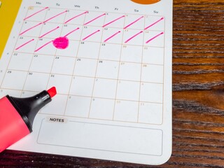 Calendar Marked with a Pink Highlighter Suggesting Planning and Schedules