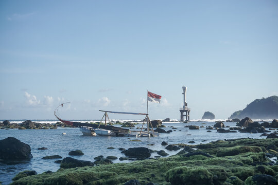 Beacon Tower in the Middle of the Sea with Waves and Clouds at pidakan beach pacitan east java indonesia