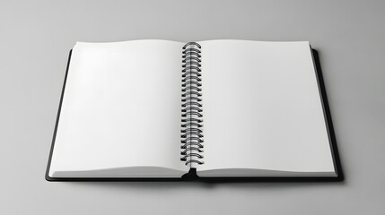 Open notebook on Grey Background: A minimalist photo showcases an open, empty notebook resting on a light grey surface, its pages inviting potential ideas, thoughts, and sketches.