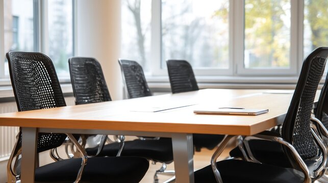 Modern meeting room with wooden table and black chairs (1)