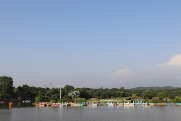 Obraz premium Sukhna Lake is a beautiful natural lake in Chandigarh in India. It has beautiful landscapes and views. Lake has boating and other attractions for kids.