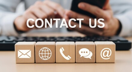 A Contact Us Concept with Communication Icons on Wooden Blocks and Businessman Using Smartphone