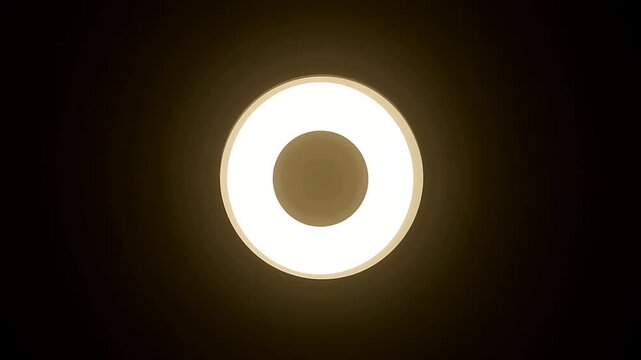 Illuminated Ring: Abstract Circular Light Source on Black Background