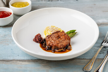 Grilled beef tenderloin with mashed potatoes, vegetables, and sauce