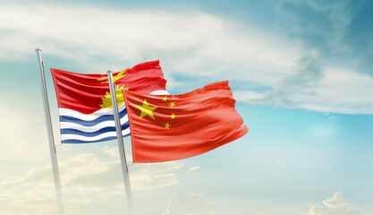 Fototapeta premium Kiribati China friendship flags are waving in the sky. Two country flag for agreement or deal. Kiribati China national flag for commitment.
