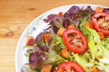 Mouthwatering Colorful Tomato and Lettuce Salad Garnished with Black Sesame