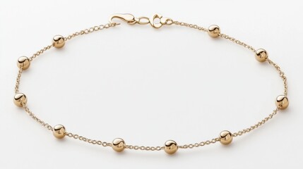 Fototapeta premium Delicate chain anklet with small charms arranged in a gentle curve on white