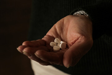 Woman holding white pills in hand. Health care medicine subscription, illness, depression, sick,...