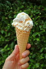 Hand Holding Delectable Salted Caramel Ice Cream Cone